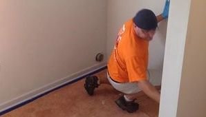Water Damage Restoration Technician Cleaning Up Mold